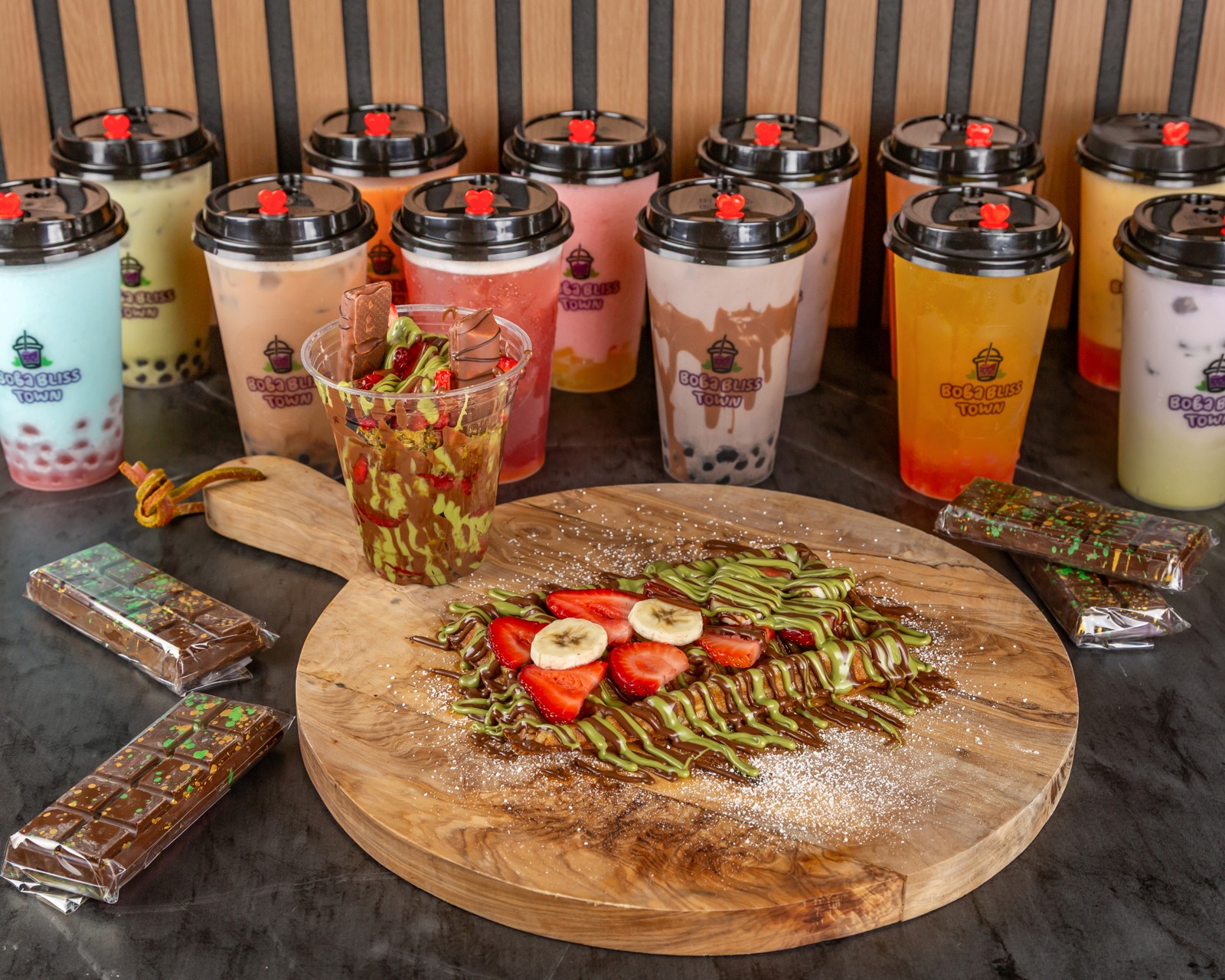 Our waffle and Dubai Strawberry Cup alongside Boba Bliss Town drinks